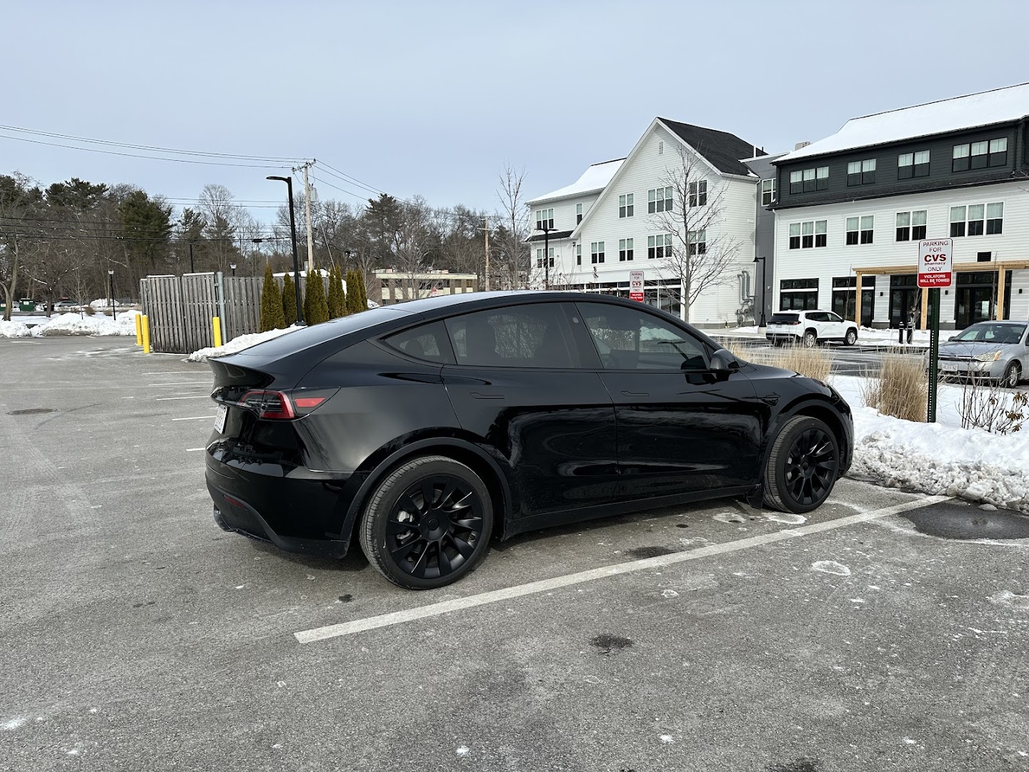 Window tinting on black Tesla Model Y at Auto Addict Car Care